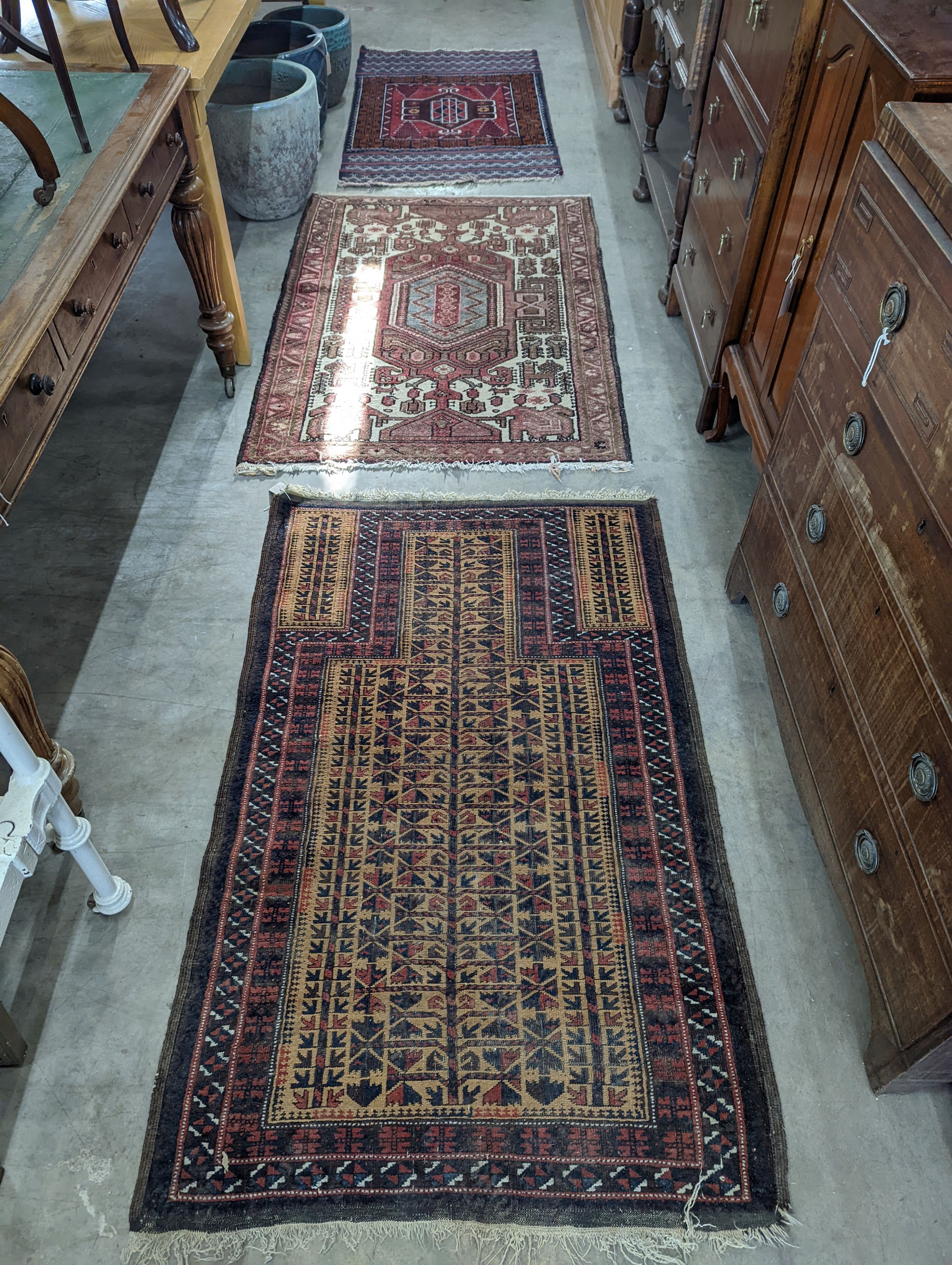 A Belouch geometric prayer rug and two Caucasian design rugs, largest 152 x 104cm